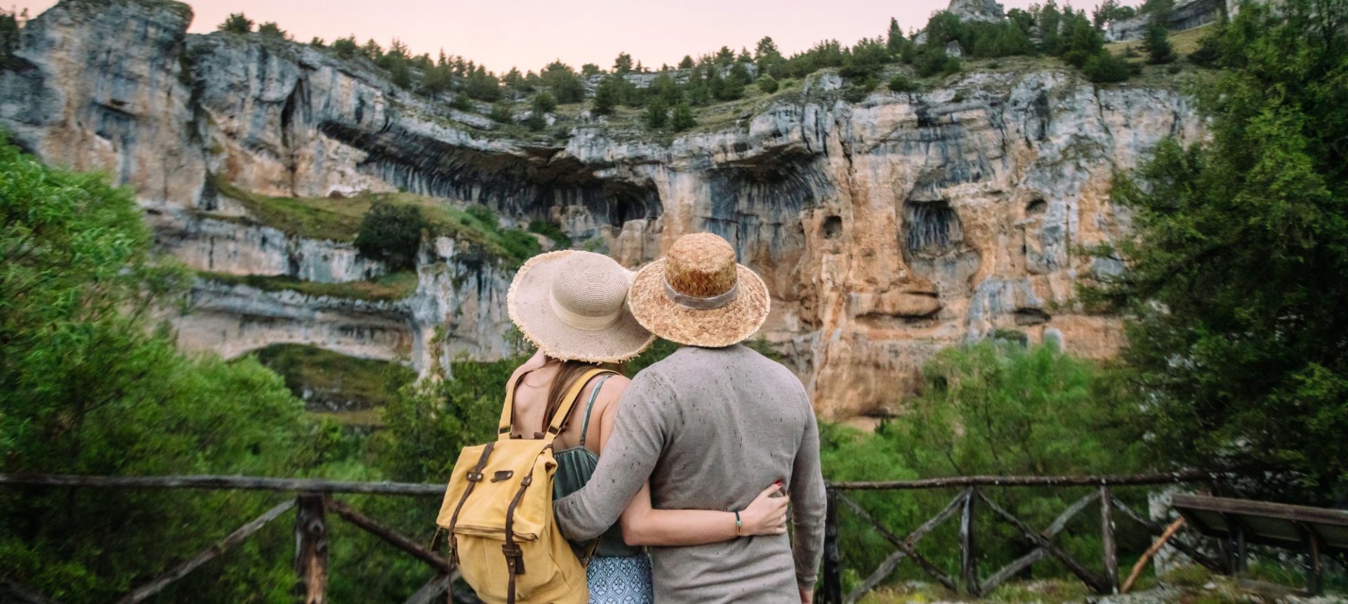 Couple in sun hats looking out at a canyon cliff, the travelers a duty of care team keeps track of abroad