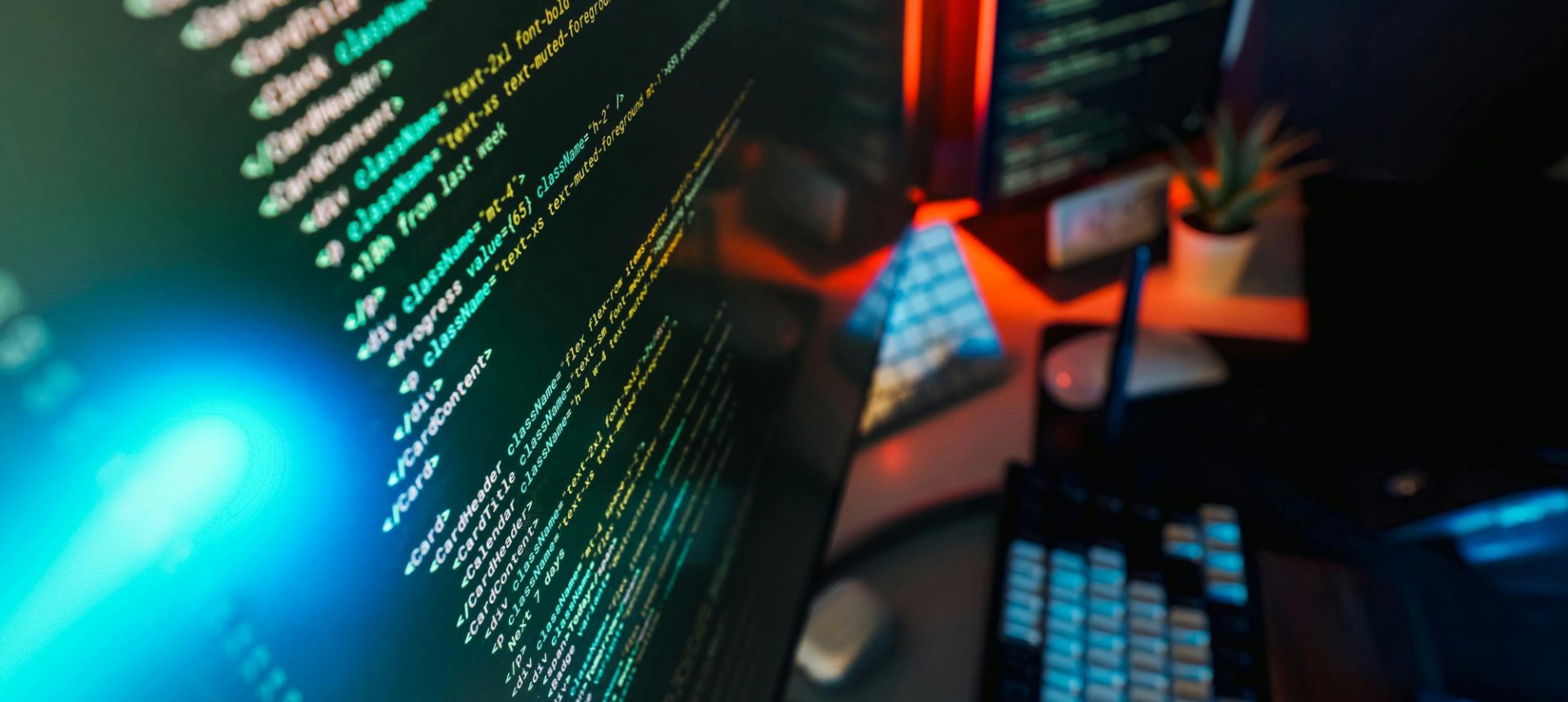 Lines of code on a monitor beside a keyboard, the systems that carry risk adjustment codes to the health plan