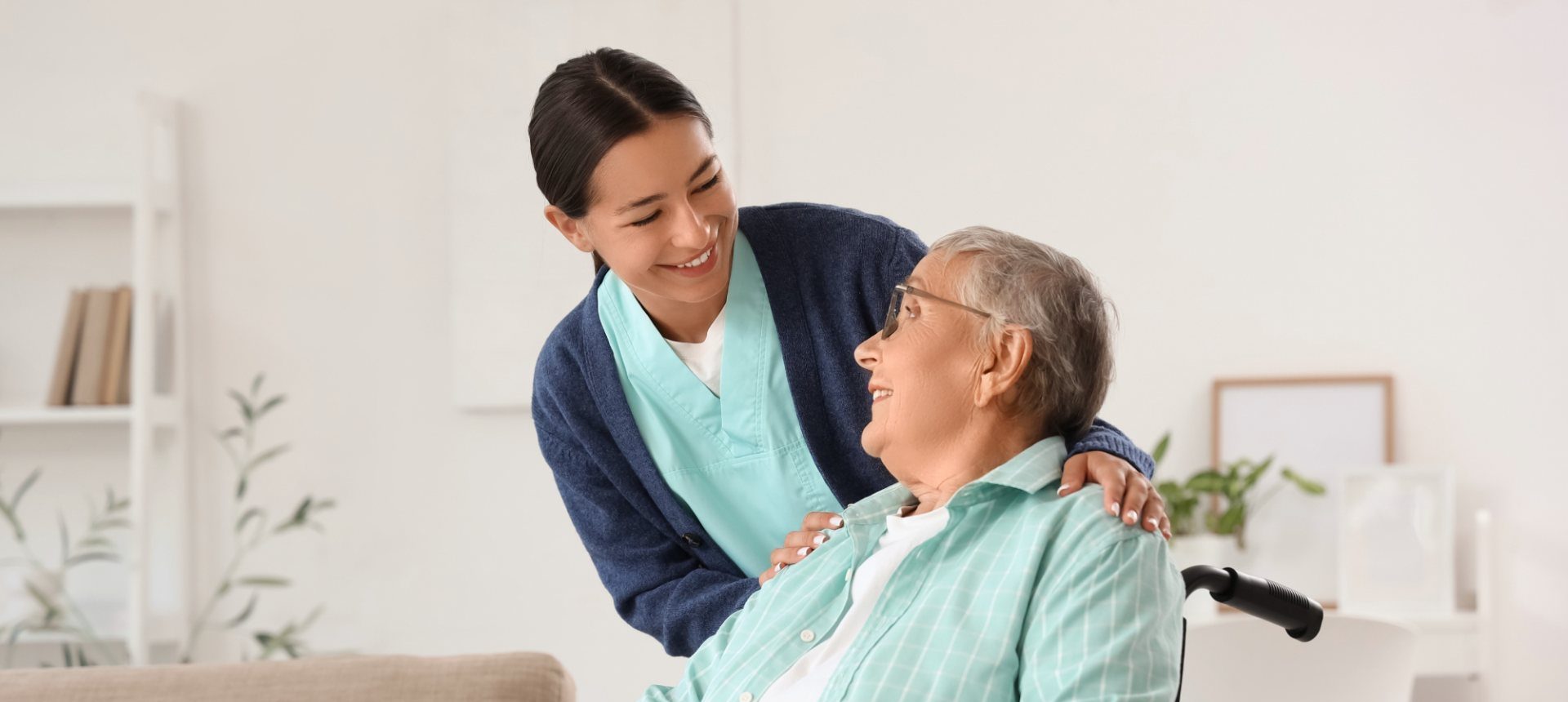 Home care nurse with an elderly patient in a wheelchair, the visit that home health and hospice billing documents