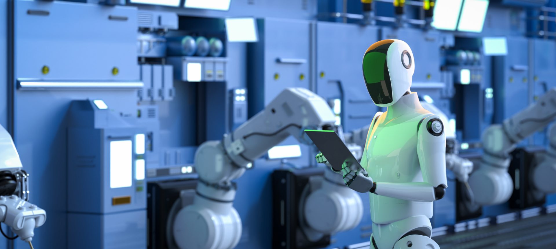 Humanoid robot holding a tablet beside robotic arms on a factory line, the machines a teleoperation desk supervises