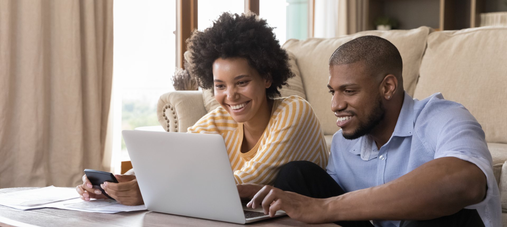 Couple reviewing their insurance policy together on a laptop at home