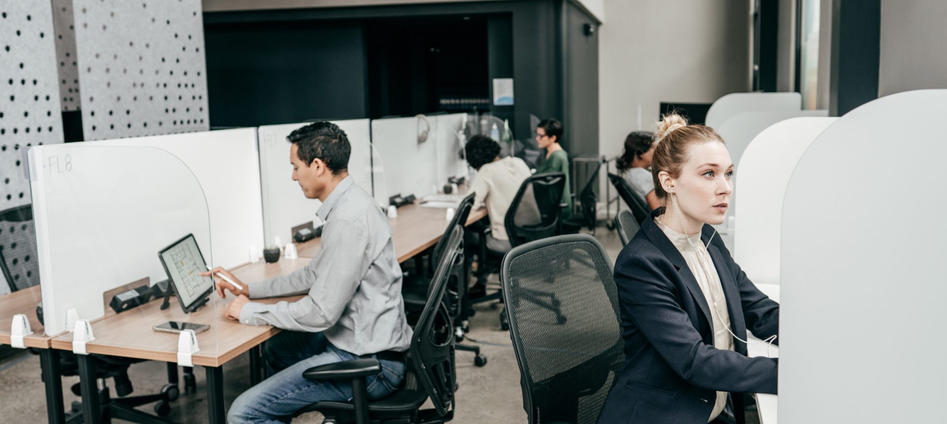 Agents working at partitioned desks on an open support floor, the help desk an MSP runs under its own name