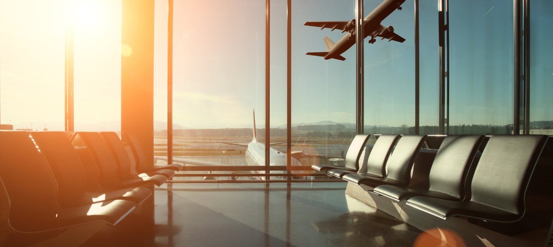 Empty airport lounge at sunrise with a plane taking off, the cancelled trip an OTA refund team works