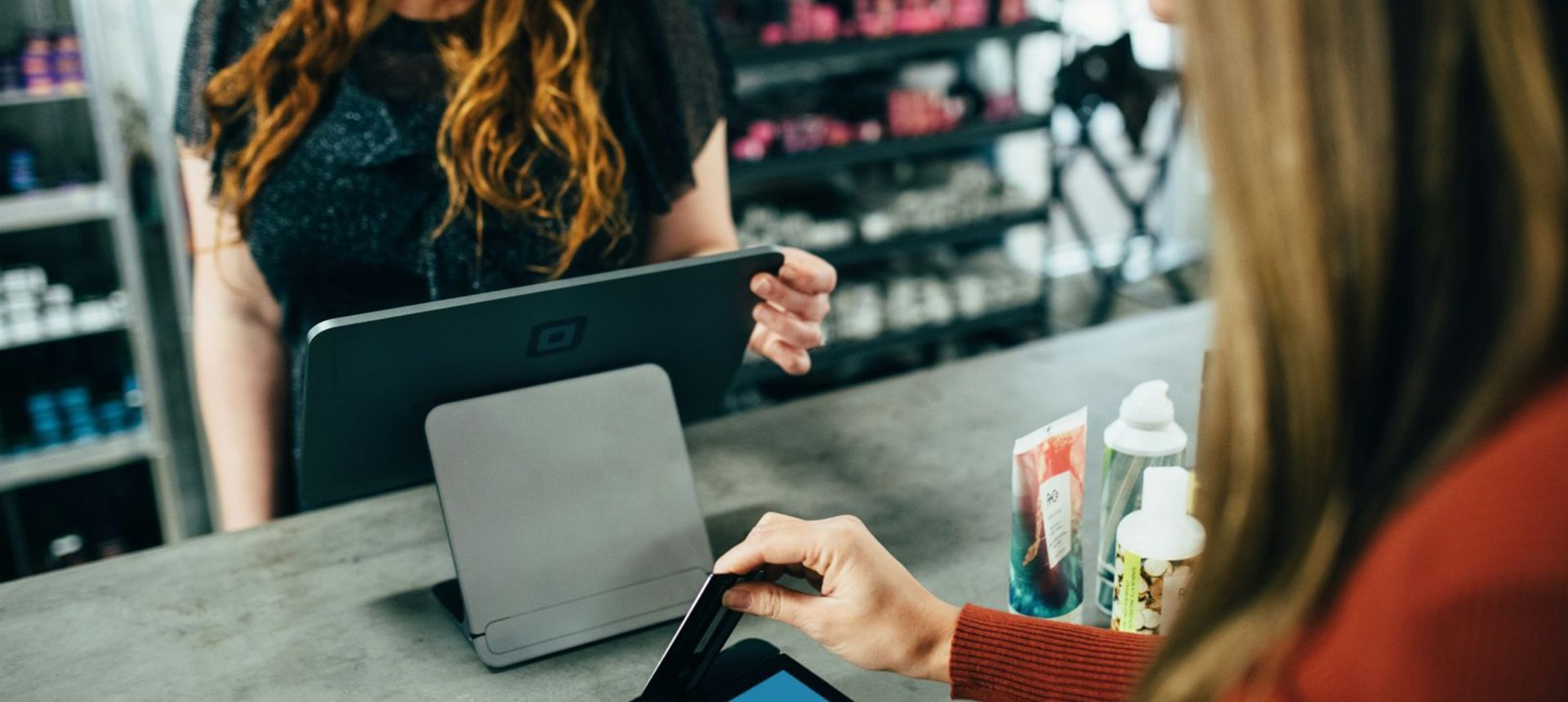 Shopper paying at a tablet checkout, the kind of purchase signal recommendation labelers judge