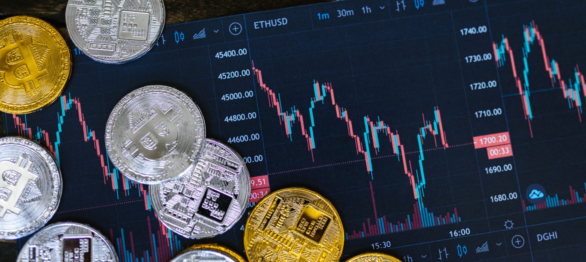 Gold and silver crypto coins spread over a live trading chart, the tokenized assets a stablecoin operations team reconciles