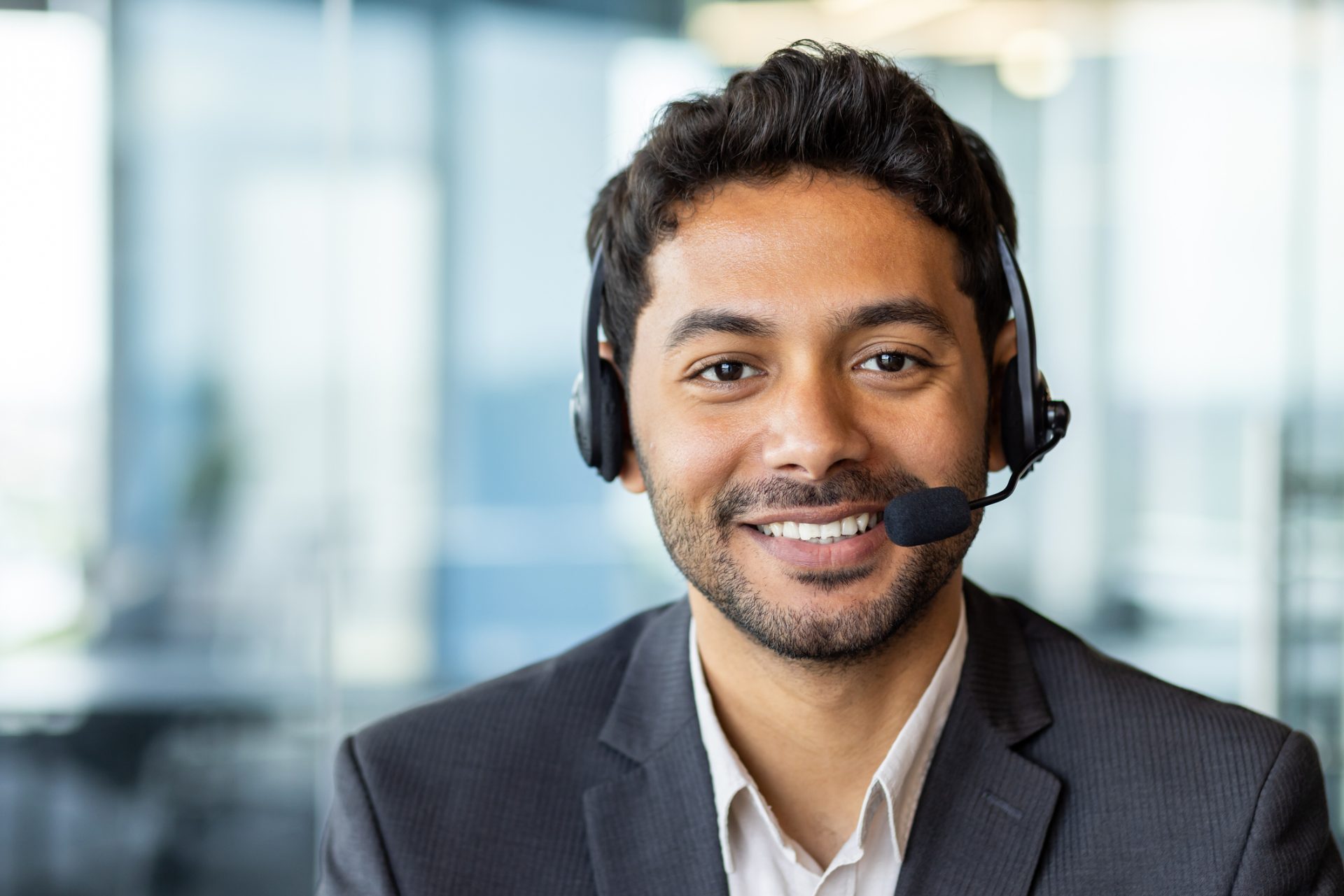 Smiling call center agent with headset on a customer call, representing a Philippines vs India call center outsourcing comparison