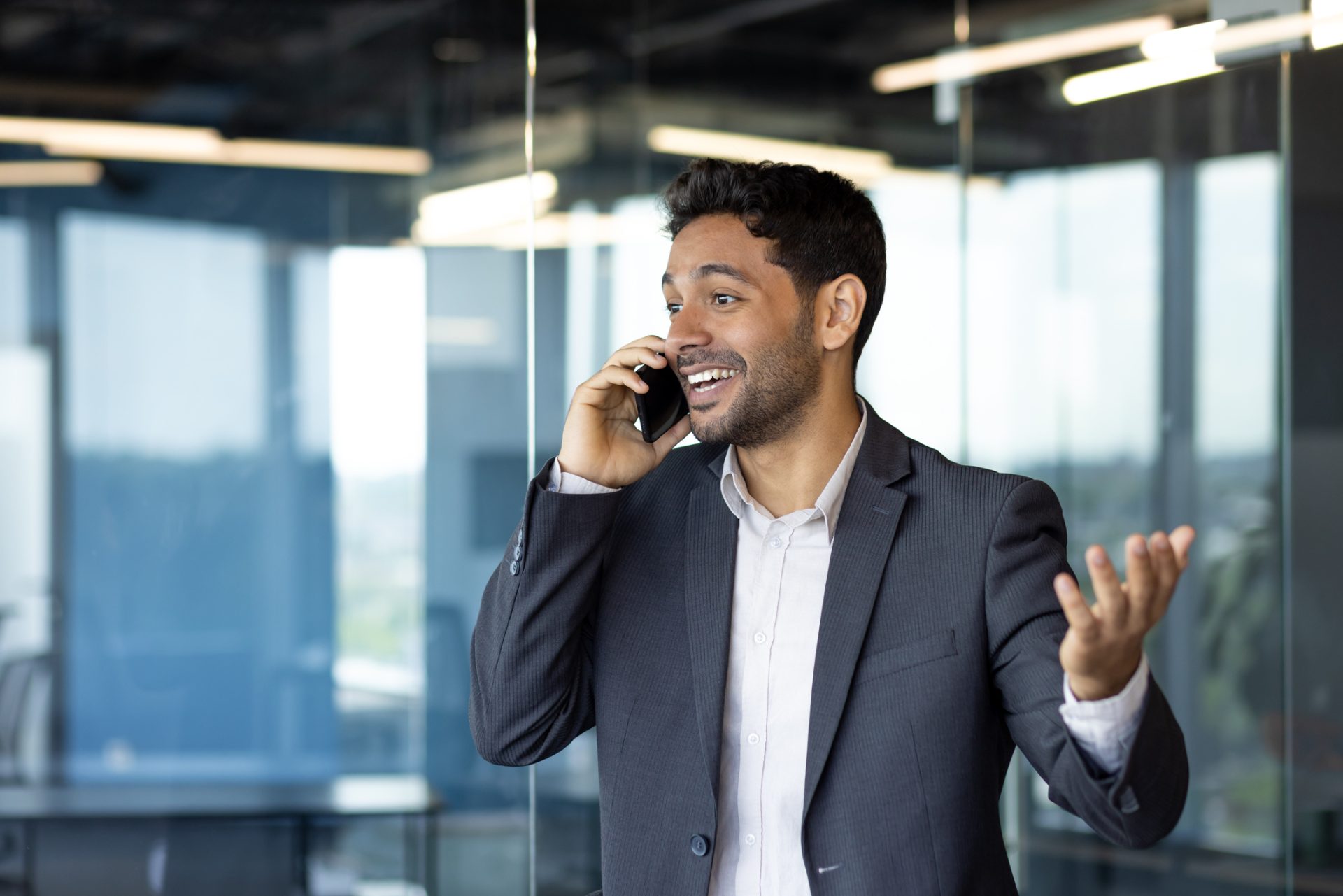 Call center executive on a phone call reviewing pricing terms in a modern office, representing call center pricing in the Philippines