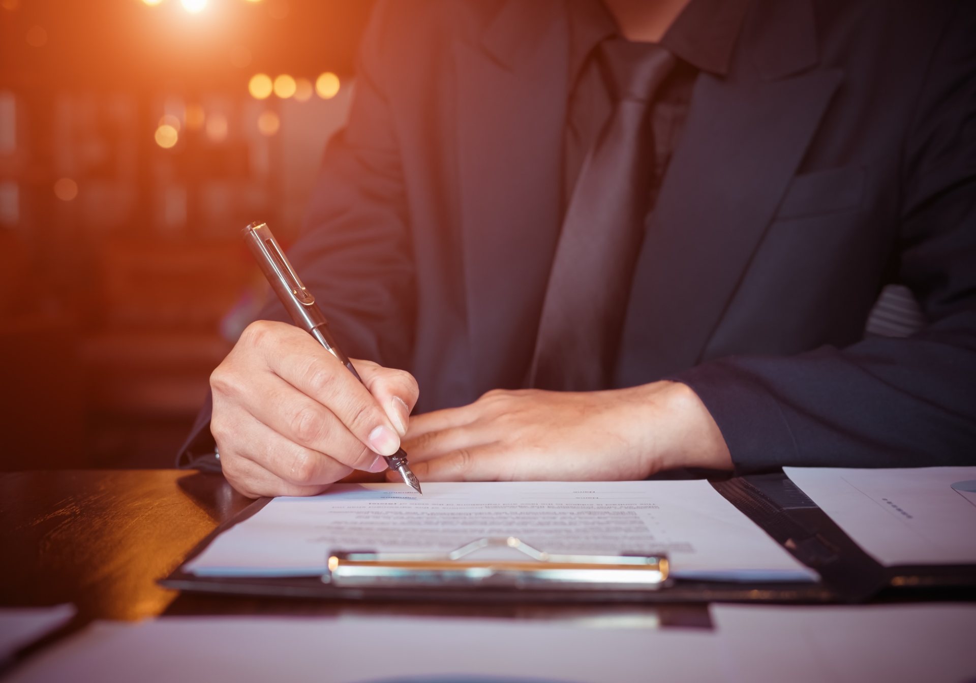 Claims professional signing a form on a clipboard, first notice of loss taken during a catastrophe surge