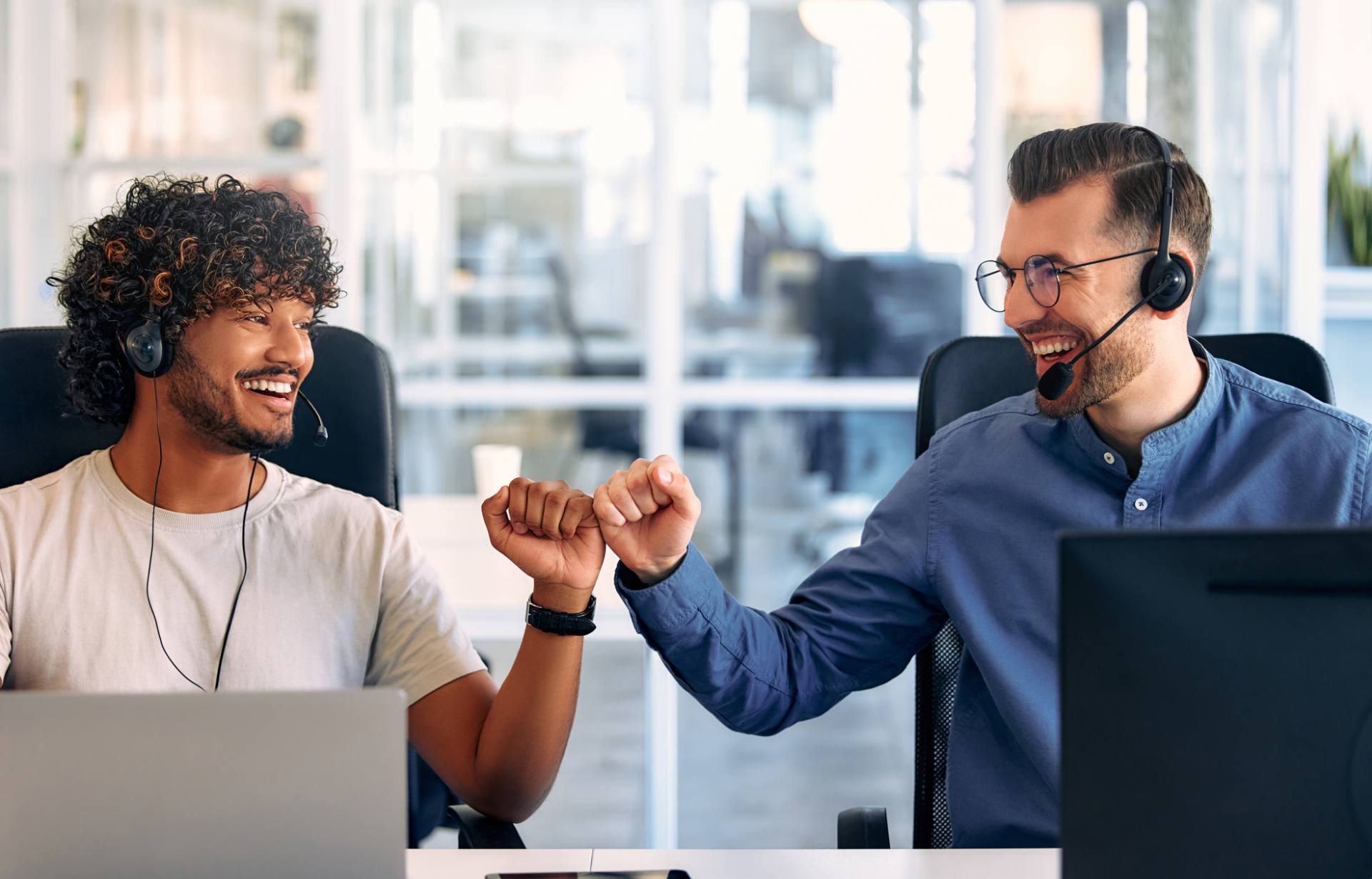 Contact center agents celebrating a resolved call at a Philippine outsourcing provider
