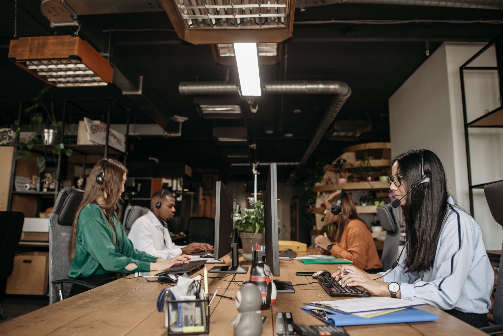 Data cleansing and enrichment team with headsets validating CRM records at shared workstations in a Philippine office