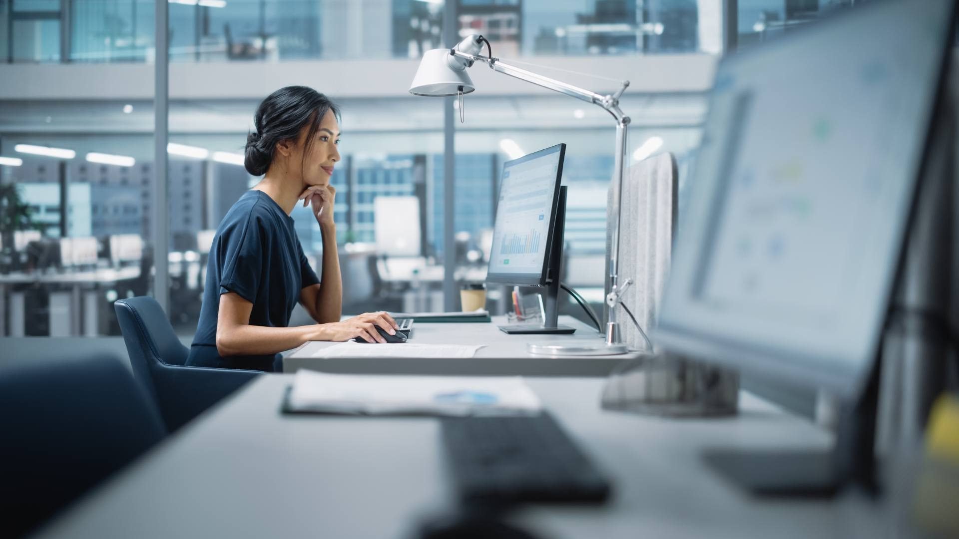 Data specialist analyzing charts on a monitor, for a post on web data extraction legal