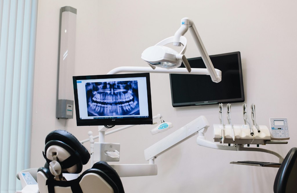 Dental treatment room with a panoramic X-ray on screen, representing dental billing and front-office support from the Philippines
