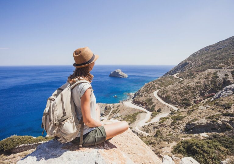 Traveler in a sun hat overlooking a coastal road and the sea, for a post on DMC ground operations