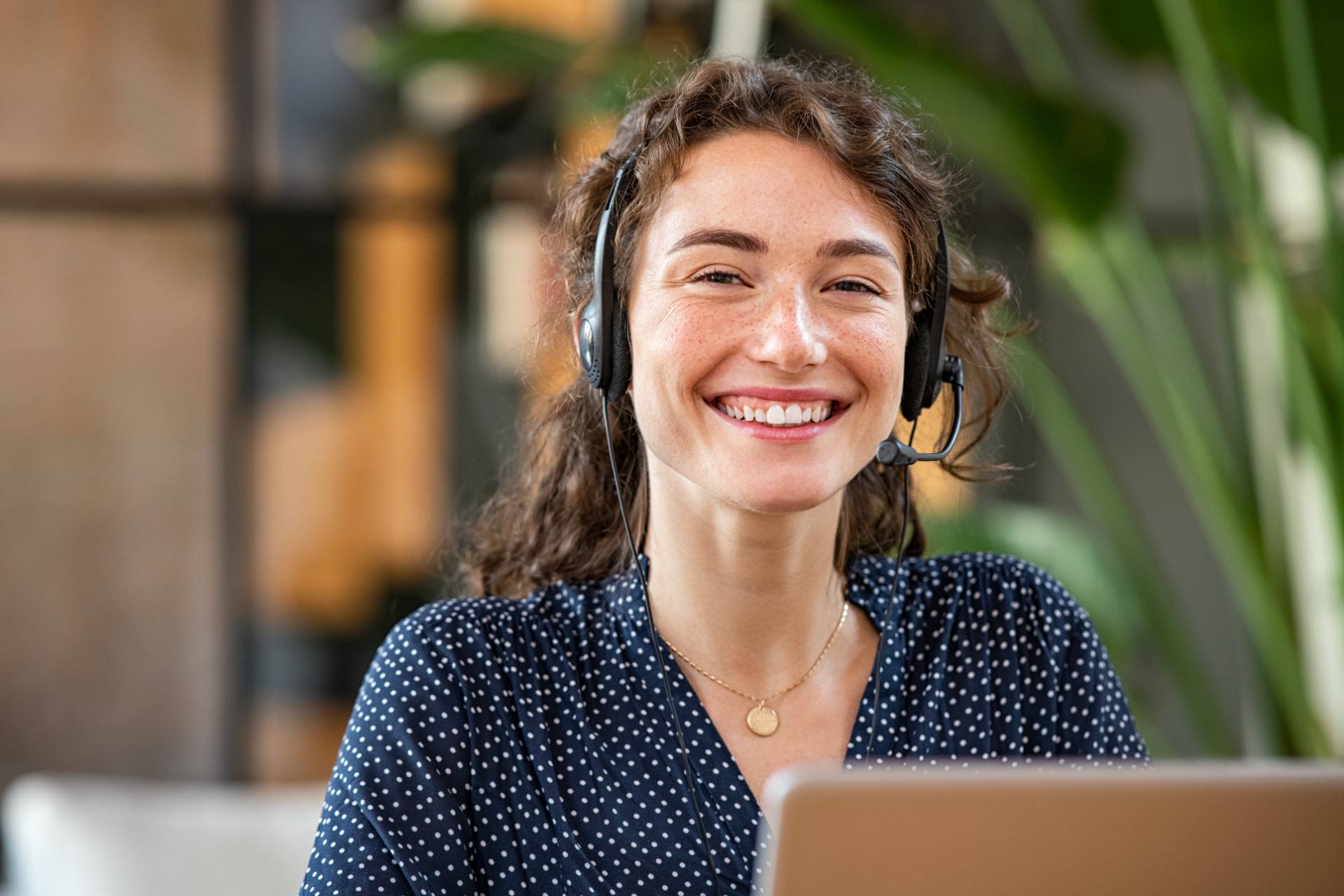Friendly support agent with headset assisting learners online, representing EdTech support by Philippine BPO teams