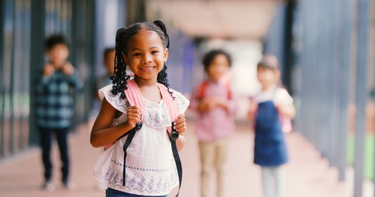 Student with a pink backpack in a school corridor, for a post on FERPA compliant student support
