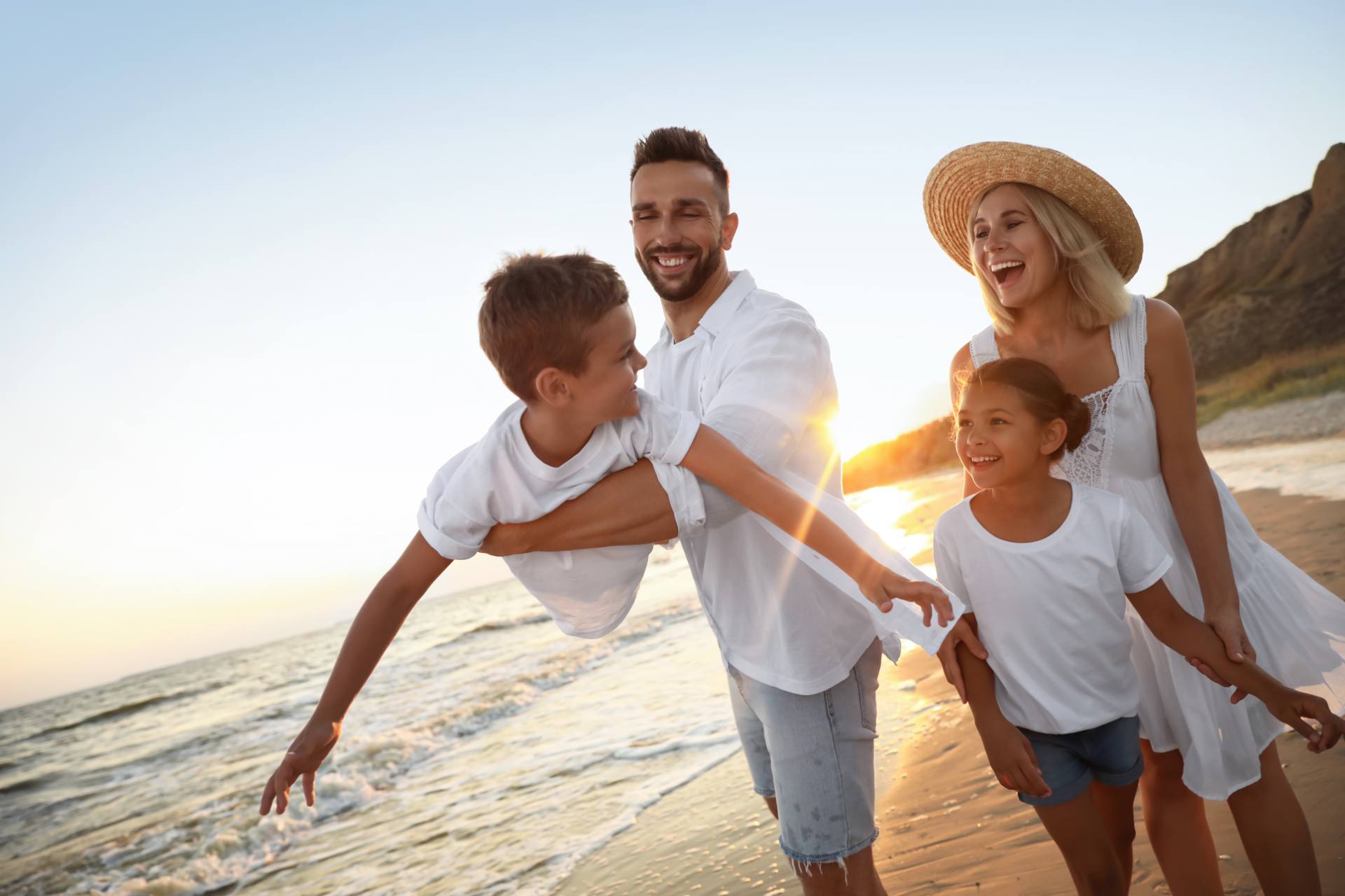 Family relaxing on a tropical beach, the hotel and resort guests hospitality support teams serve