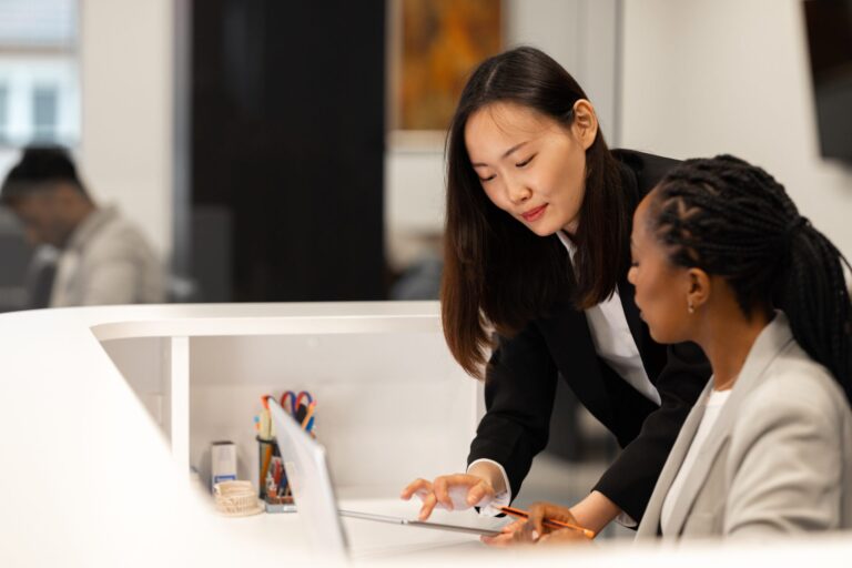 Financial services specialists reviewing account data at a desk, for a post on specialist vs generalist providers