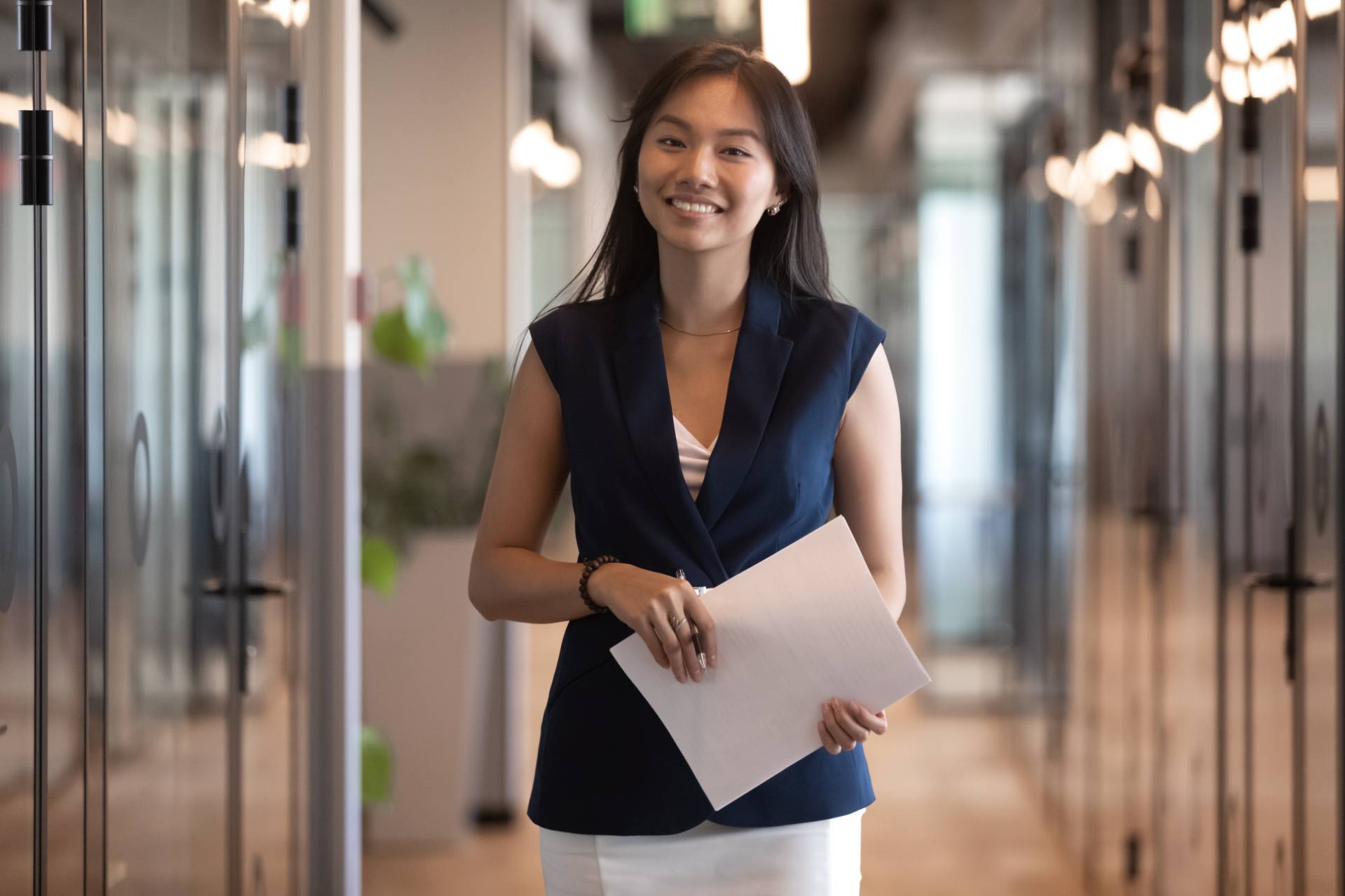 Underwriting specialist holding policy documents, for a post on underwriting submission triage