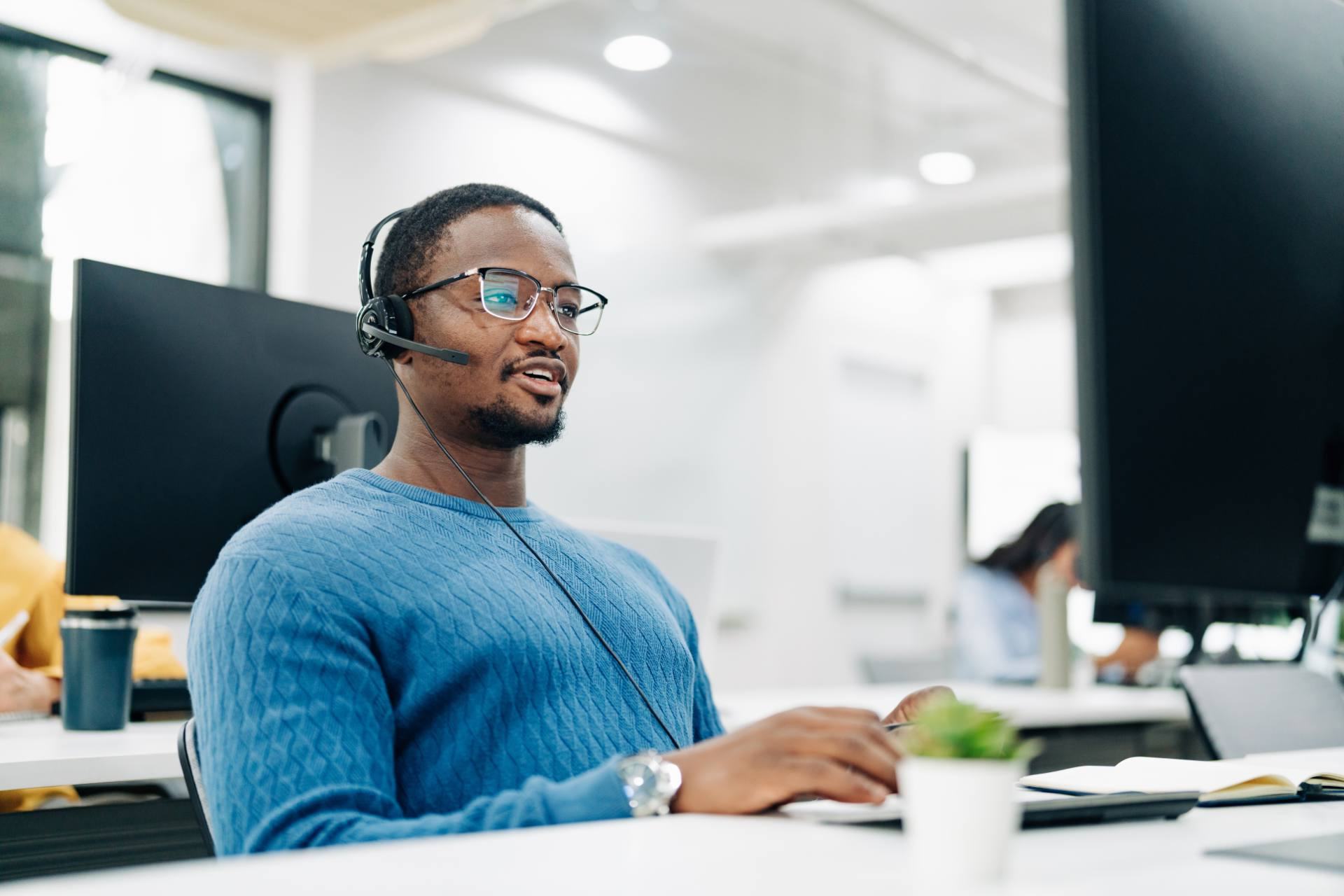 Insurtech support agent with headset assisting a policyholder at a Philippine outsourcing provider