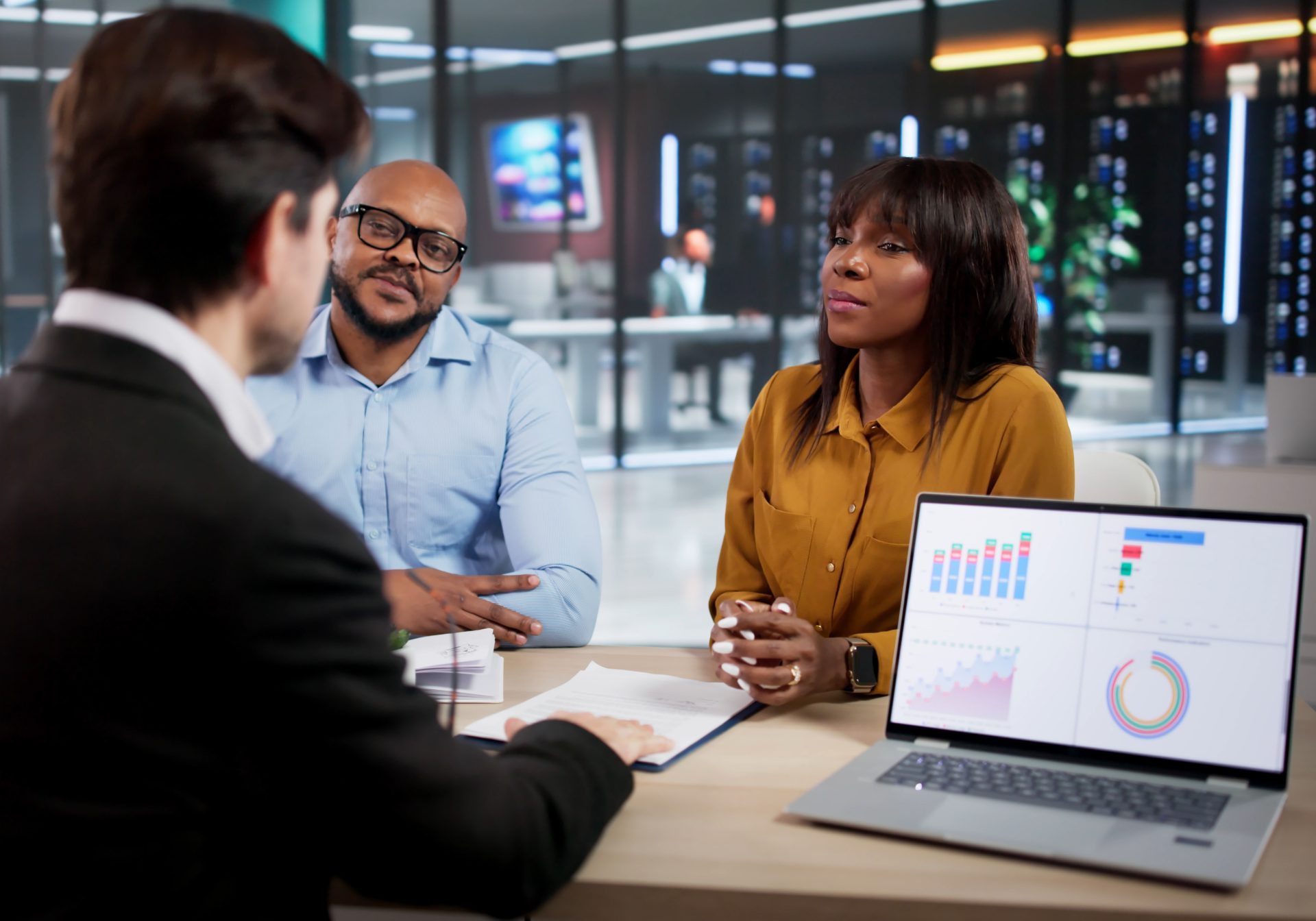 Partner team reviewing bank connection dashboards on a laptop, keeping open banking APIs running