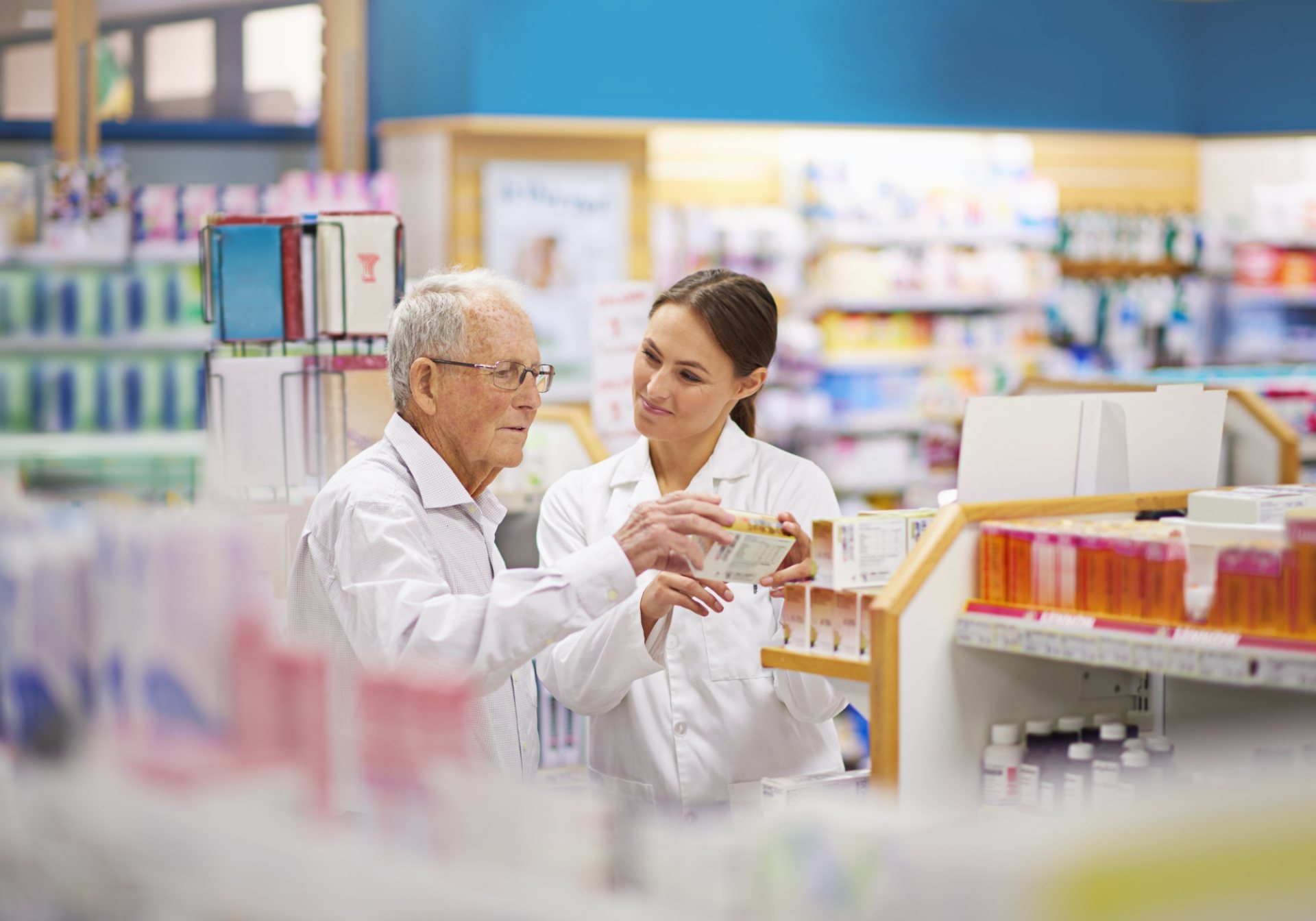 Pharmacist explaining a medication to an older customer, the questions a medical information line answers