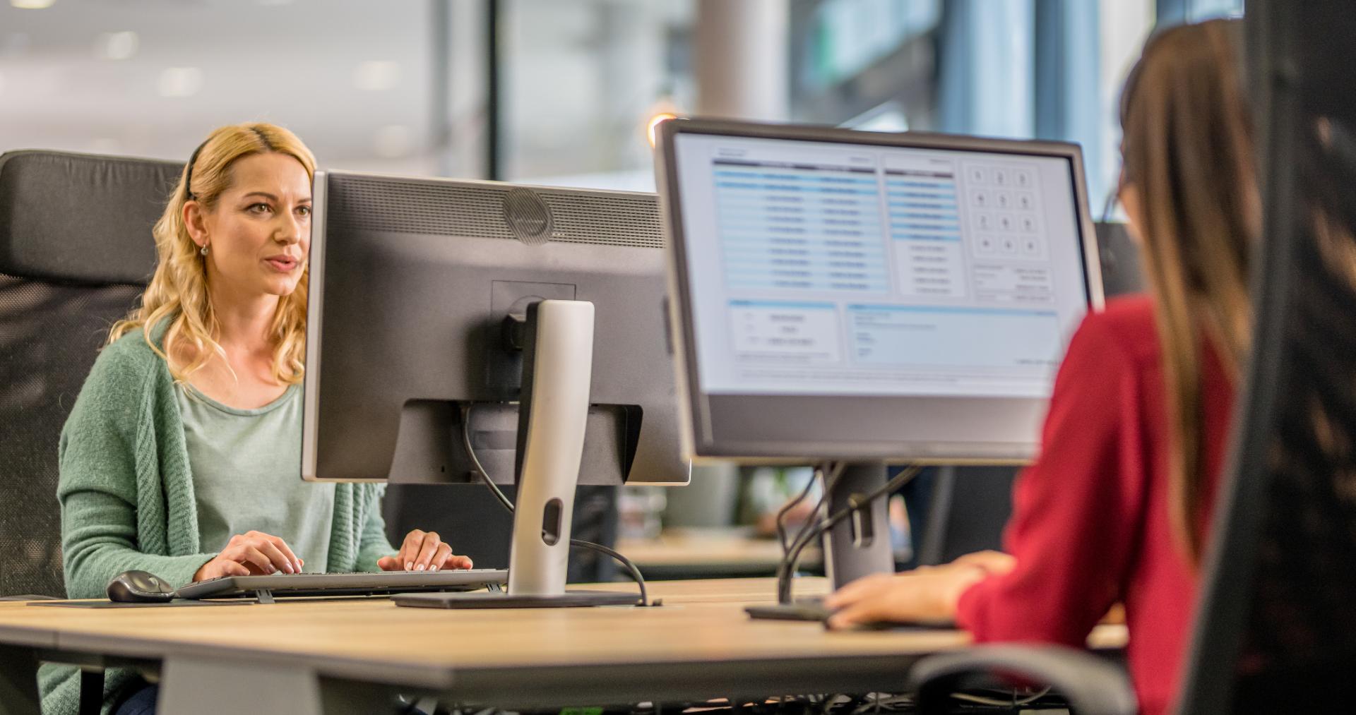 Customer experience agents with headsets working at dual-monitor workstations on the floor of a Philippine BPO delivery center, representing PITON-Global's enterprise delivery capabilities
