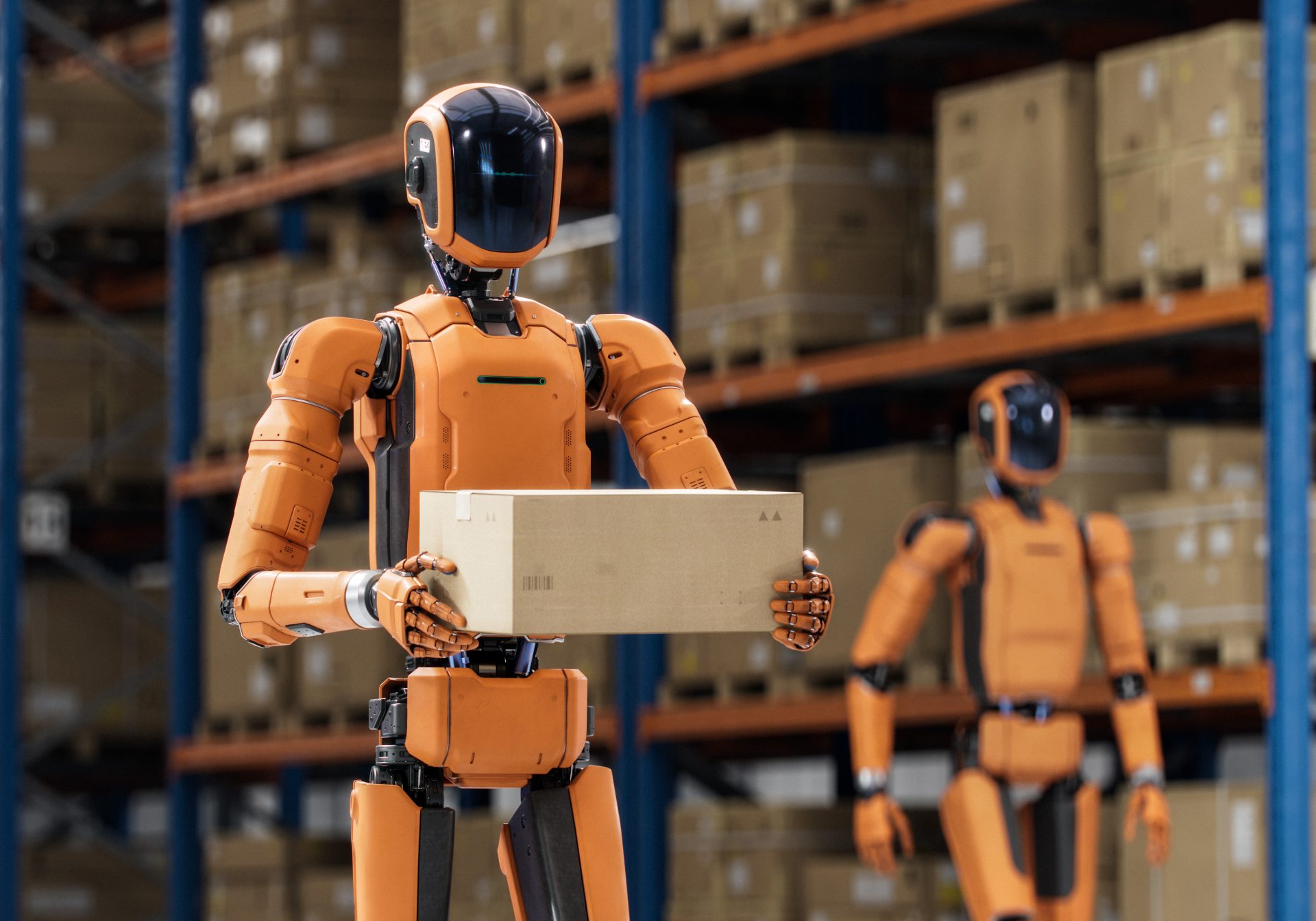 Humanoid robots carrying boxes between warehouse racks, the tasks physical AI data collection records