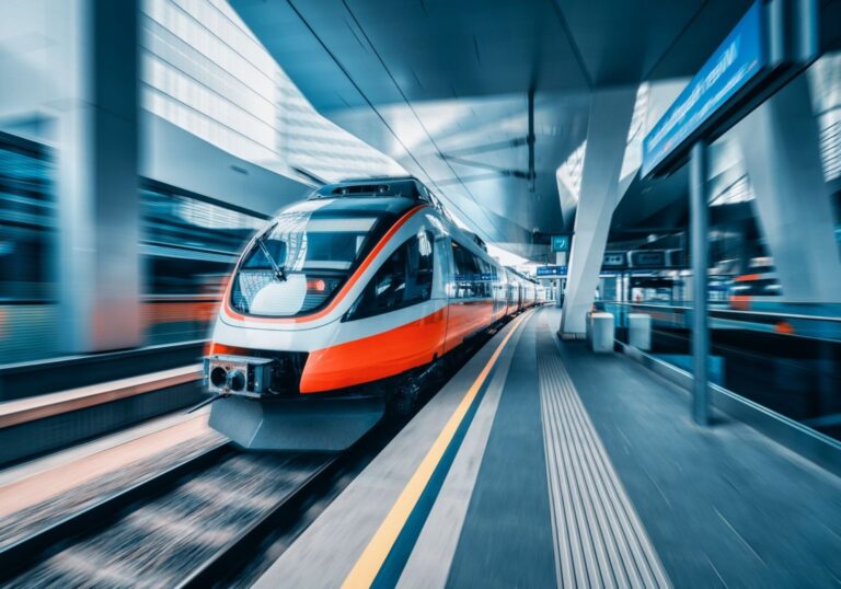 High-speed train arriving at a modern station platform, for a post on multimodal missed connection