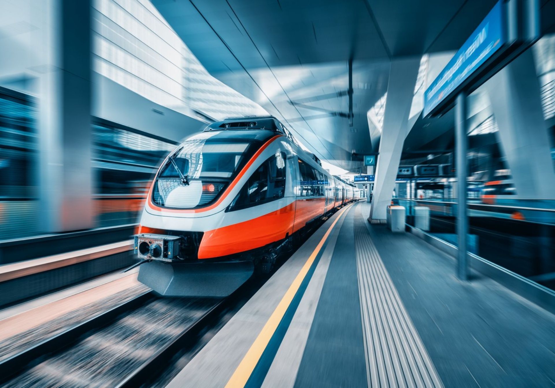 High-speed train arriving at a modern station platform, one leg of a multi-modal itinerary
