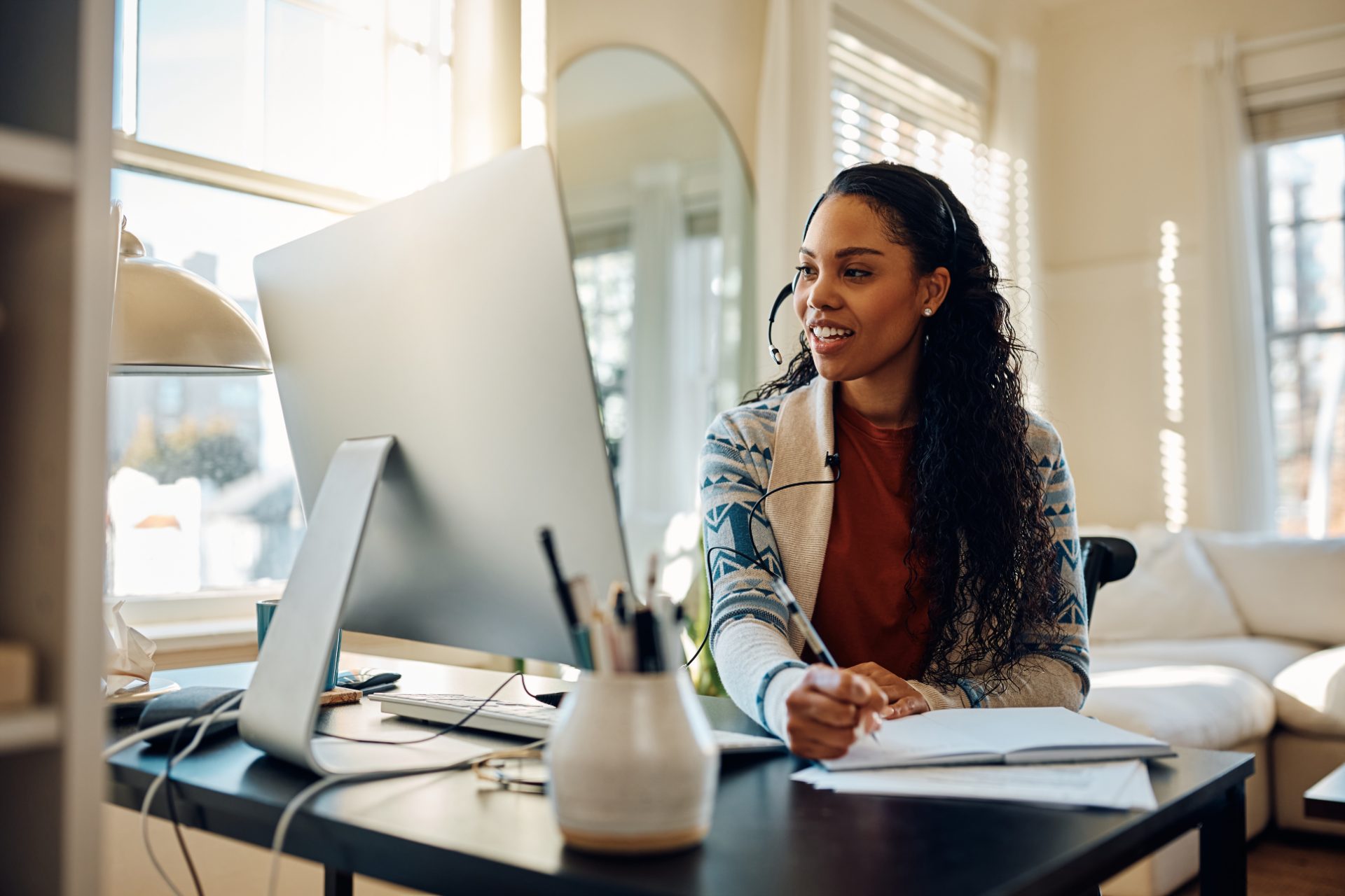 Customer support agent working at a desk in a small office, representing small business call center outsourcing to the Philippines