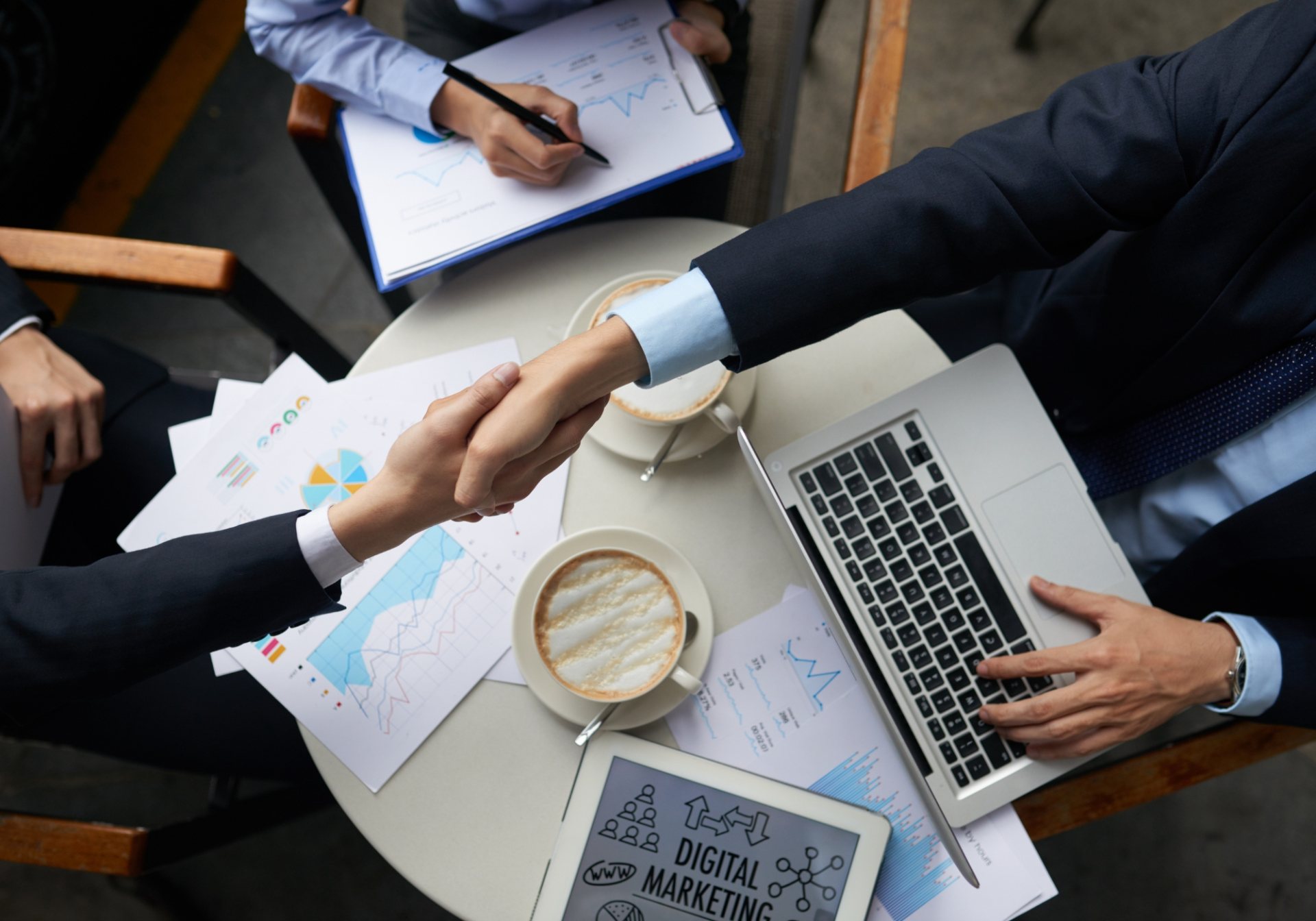 Handshake over financial reports and a laptop, the settlement that closes a subrogation recovery